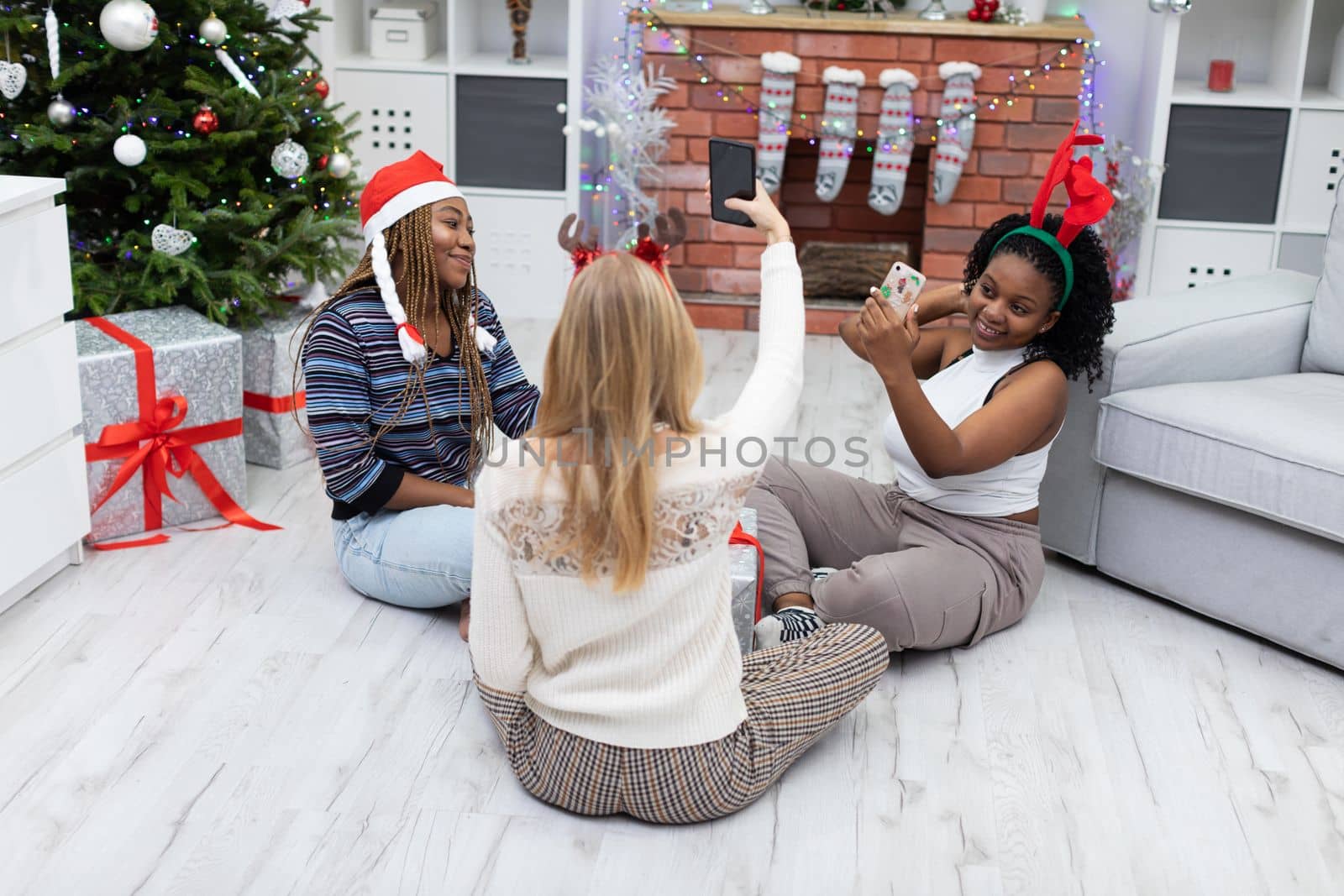 Three virgins celebrate Christmas together. Joyful photos taken with a smartphone. Selfie is a keepsake for selfies and on social media.