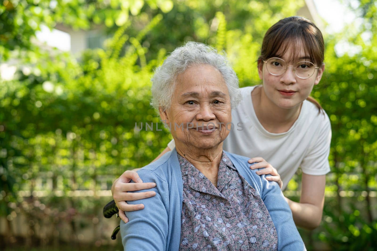 caregiver help and care Asian senior woman patient sitting on wheelchair at nursing hospital ward, healthy strong medical concept.