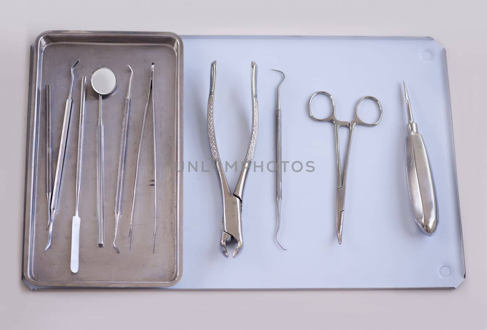 The tools of the dentistry trade. a variety of dentists tools lying on a tray. by YuriArcurs