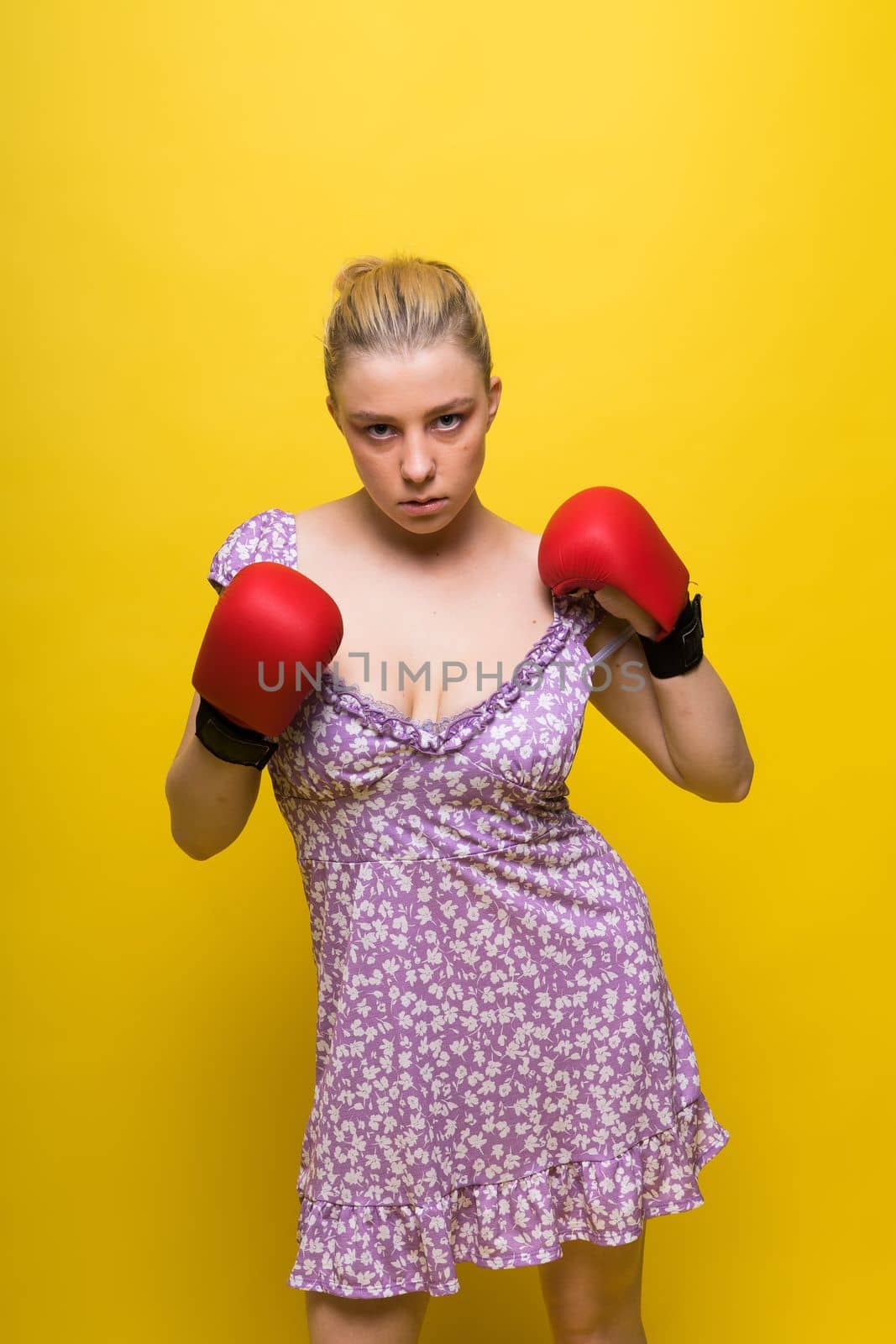 Boxer, seductive confident female boxer with gloves studio, sporty woman posing looking to camera.