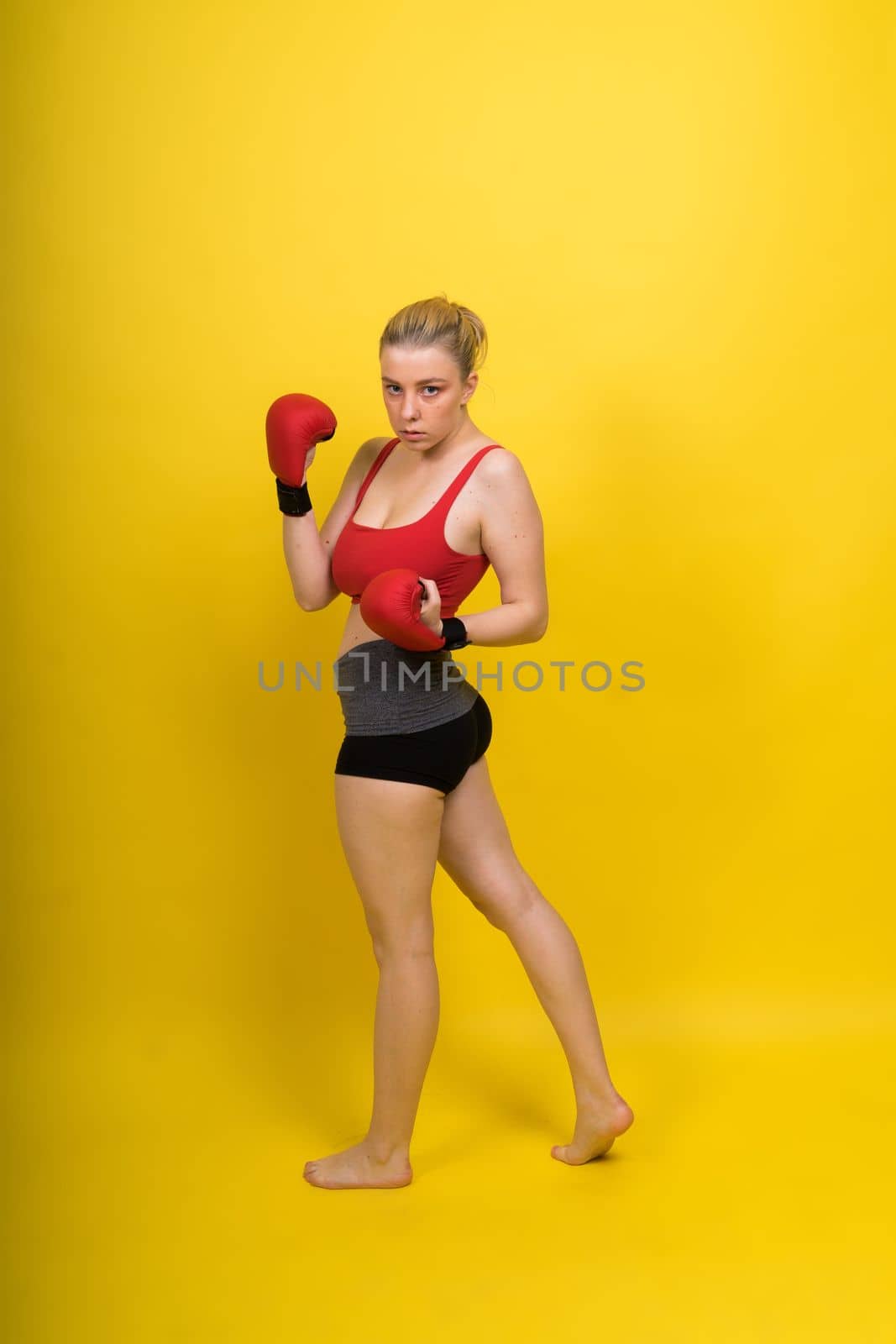 Boxer, seductive confident female boxer with gloves studio, sporty woman posing looking at camera. by Zelenin