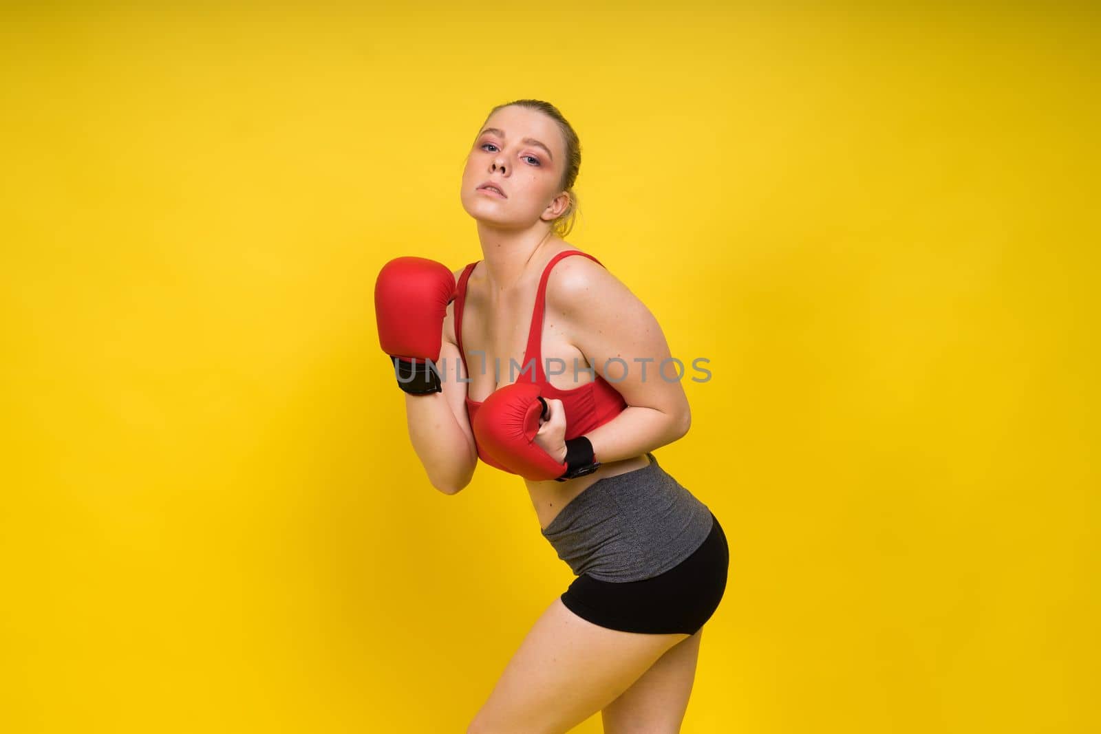 Boxer, seductive confident female boxer with gloves studio, sporty woman posing looking at camera. by Zelenin