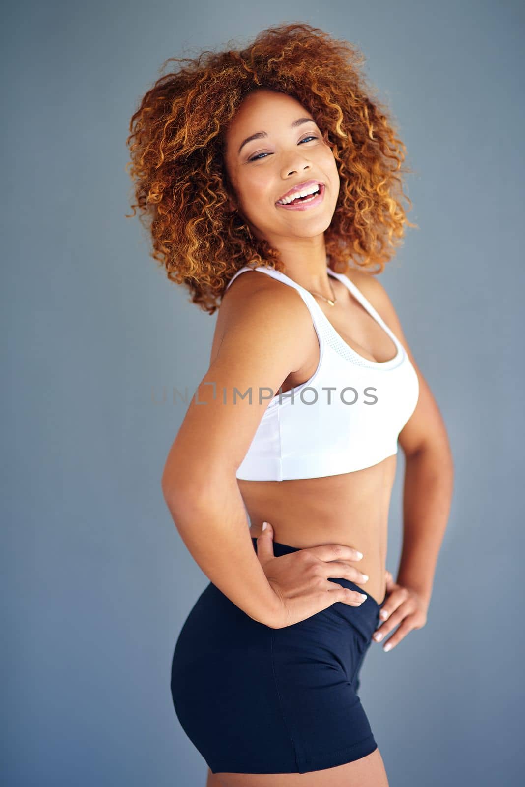 Im getting slimmer and healthier everyday. a sporty young woman posing against a grey background