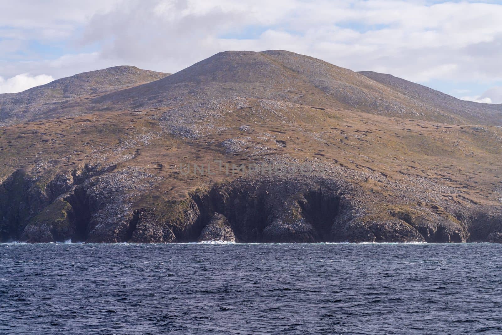 Windswept hills and cliffs on Hornos Island in Chile near Cape Horn