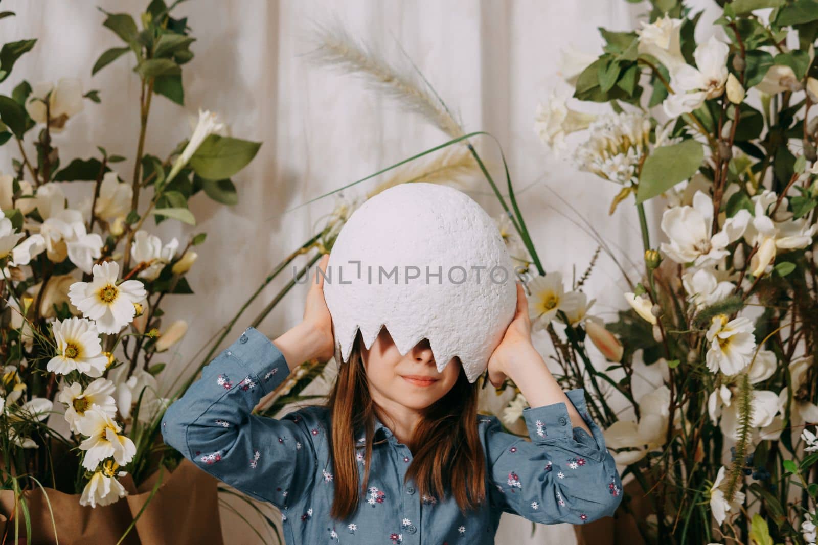 Girl in a beautiful Easter photo zone with flowers, eggs, chickens and Easter bunnies. Happy Easter holiday. by Annu1tochka