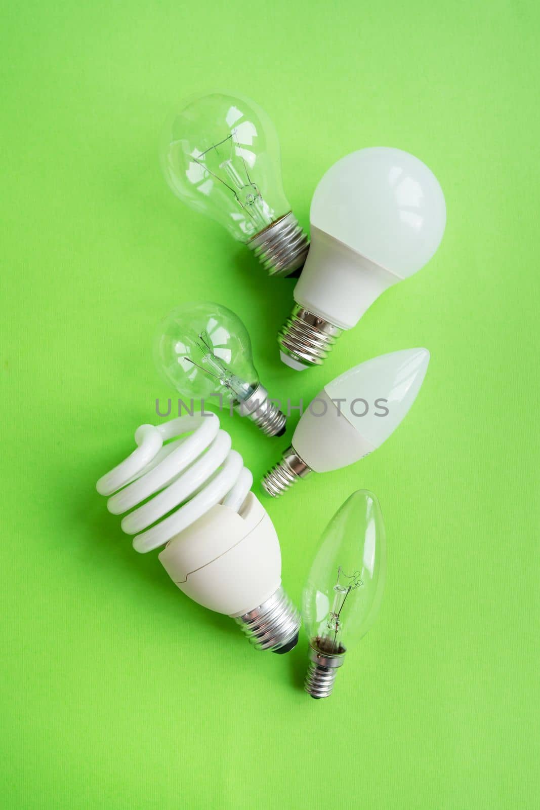 A set of different types of LED lamps isolated on a green background. Energy-saving lamps