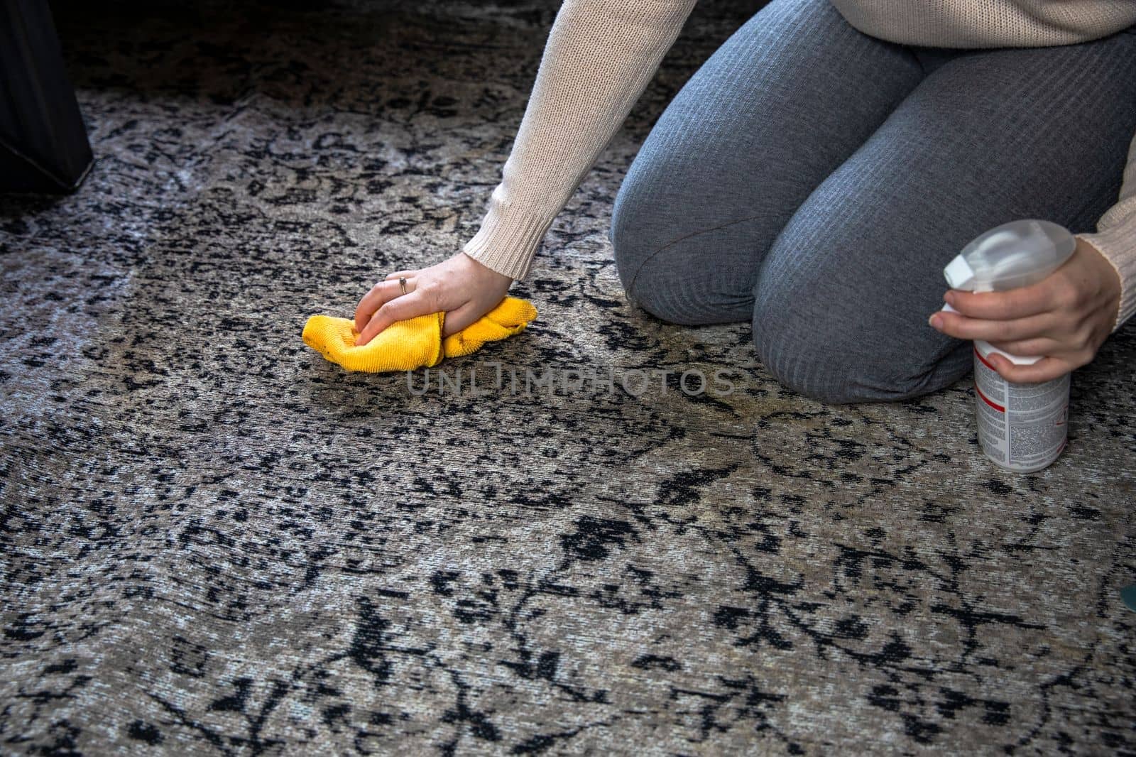 Female cleaning carpet with cloth and sprayer close up, Dirty brown coffee stain, woman cleaning home lifestyle