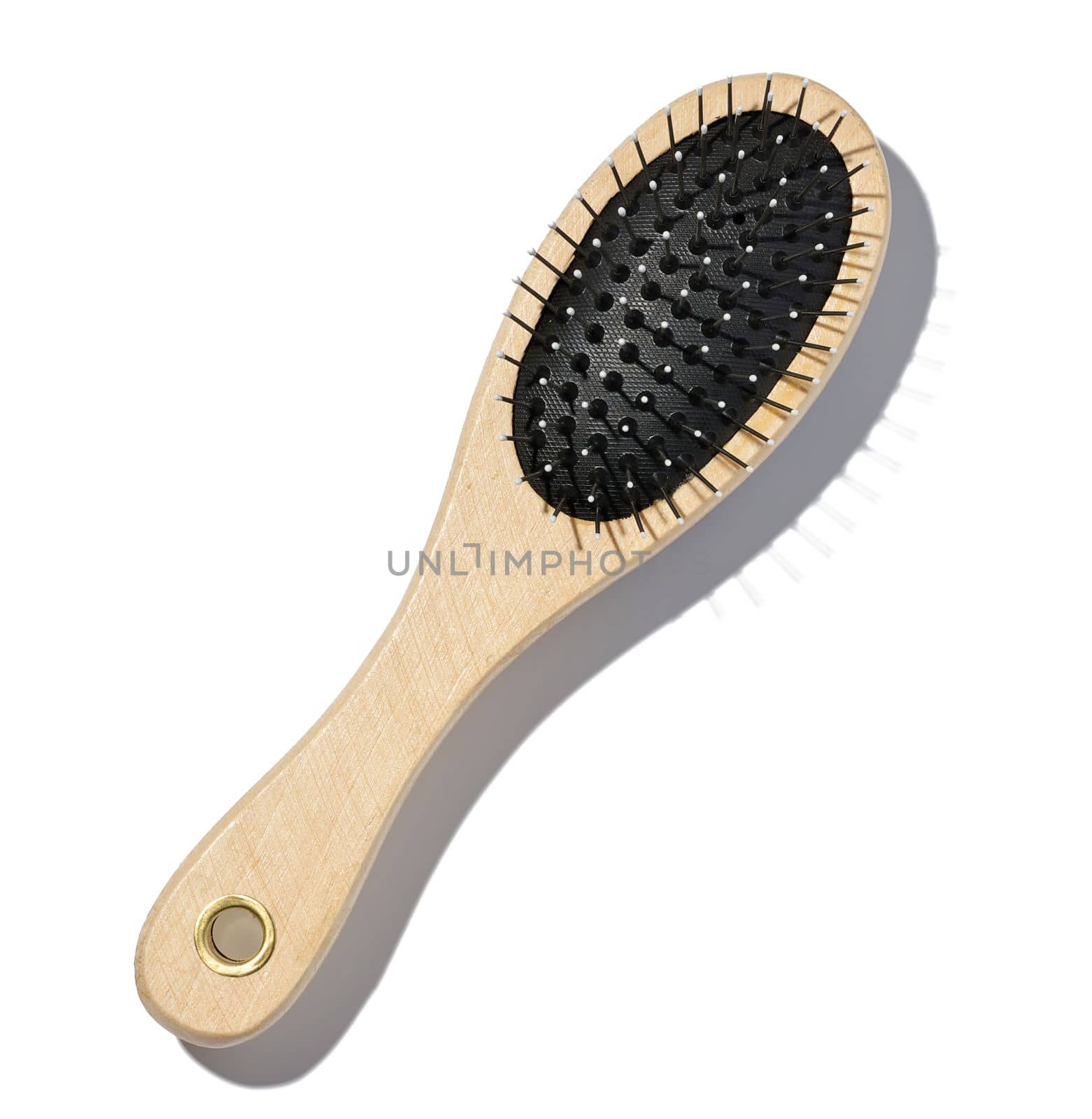 Wooden hairbrush on a white isolated background, top view by ndanko