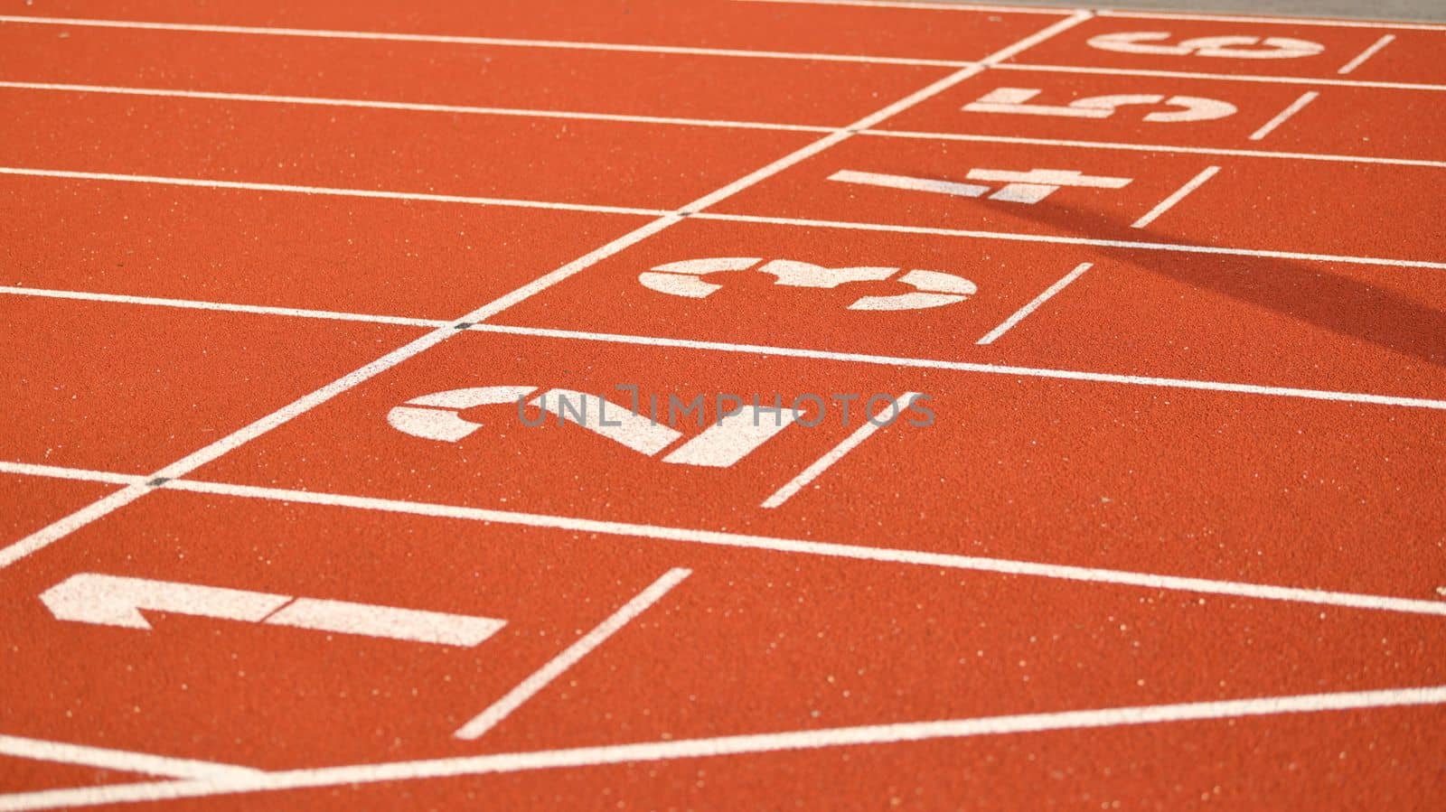 The red runway is numbered in a stadium