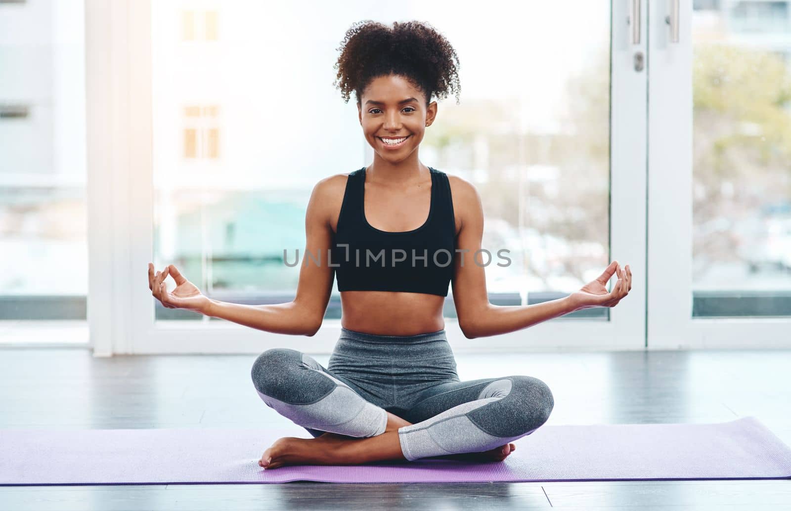 Yoga brings you back to being you. a beautiful young woman practising yoga in a studio