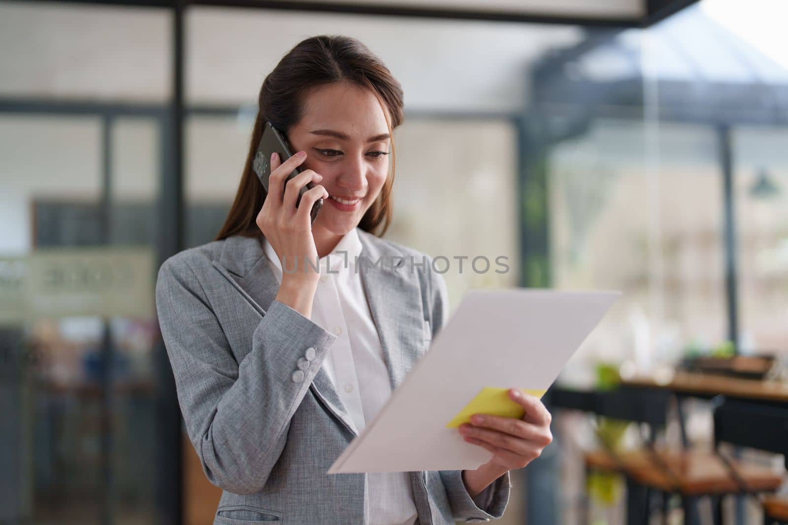 Beautiful business woman talking on the mobile phone. Management, planning and networking phone call concept