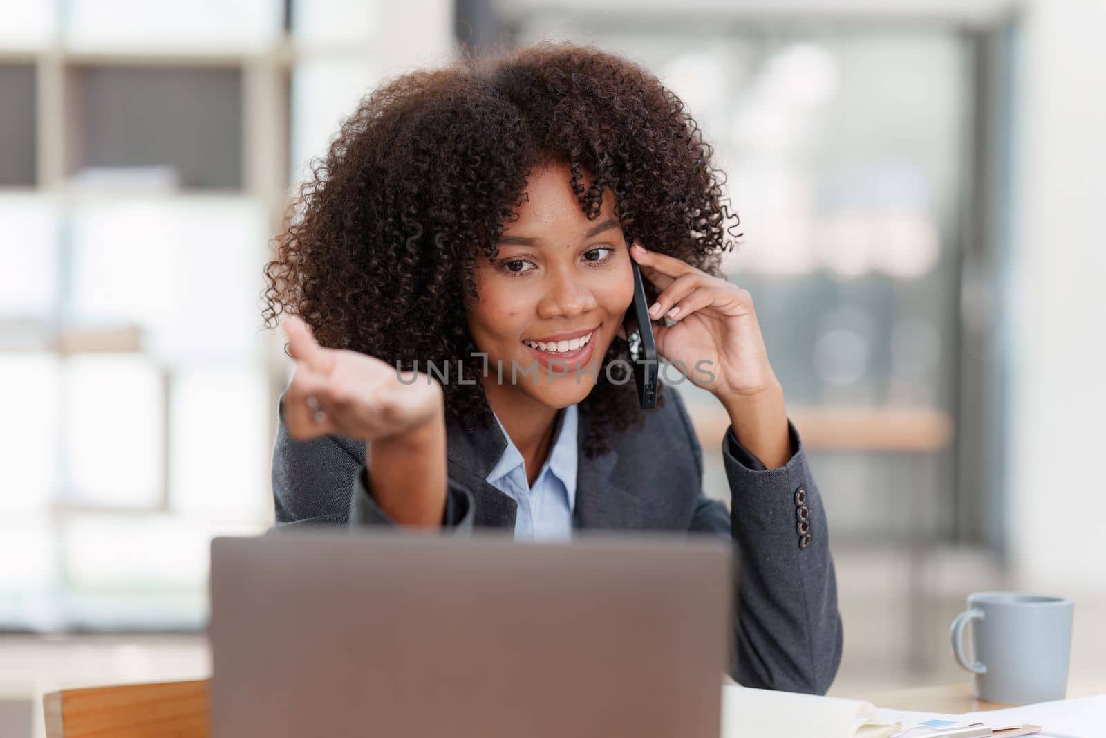American african business woman talking on the mobile phone. Management, planning and networking phone call concept. by itchaznong