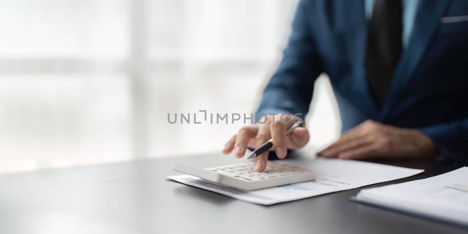 Businessman calculating the financial statement of his business. Accounting and Tax.