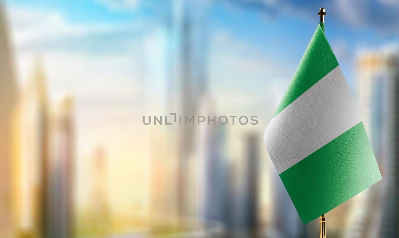 Small flags of the Nigeria on an abstract blurry background.