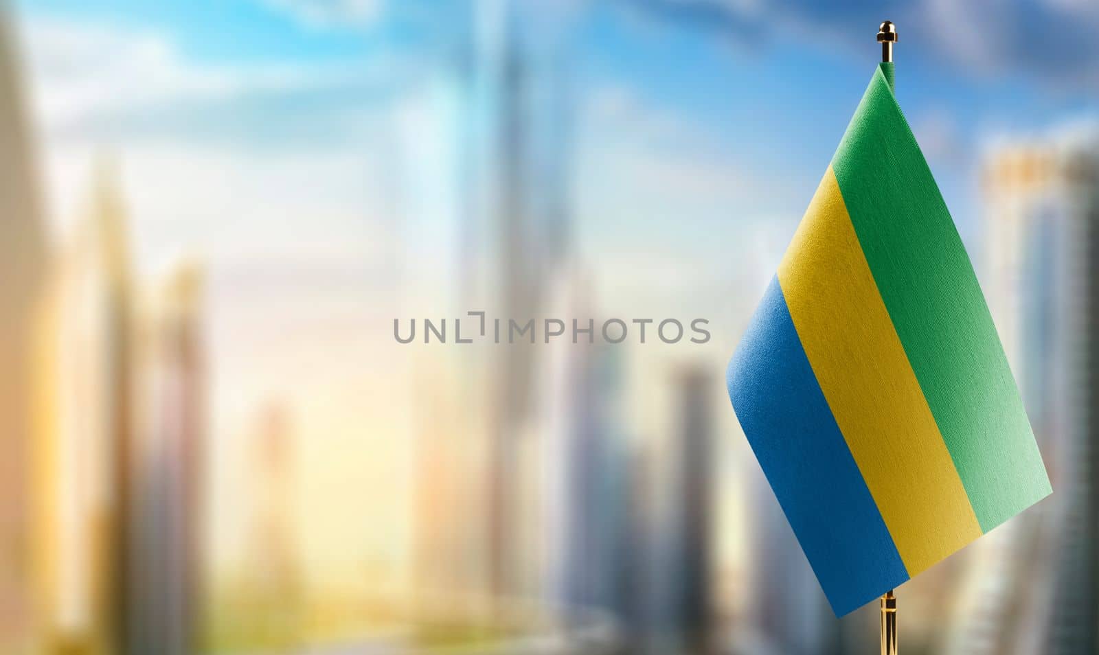 Small flags of the Gabon on an abstract blurry background.