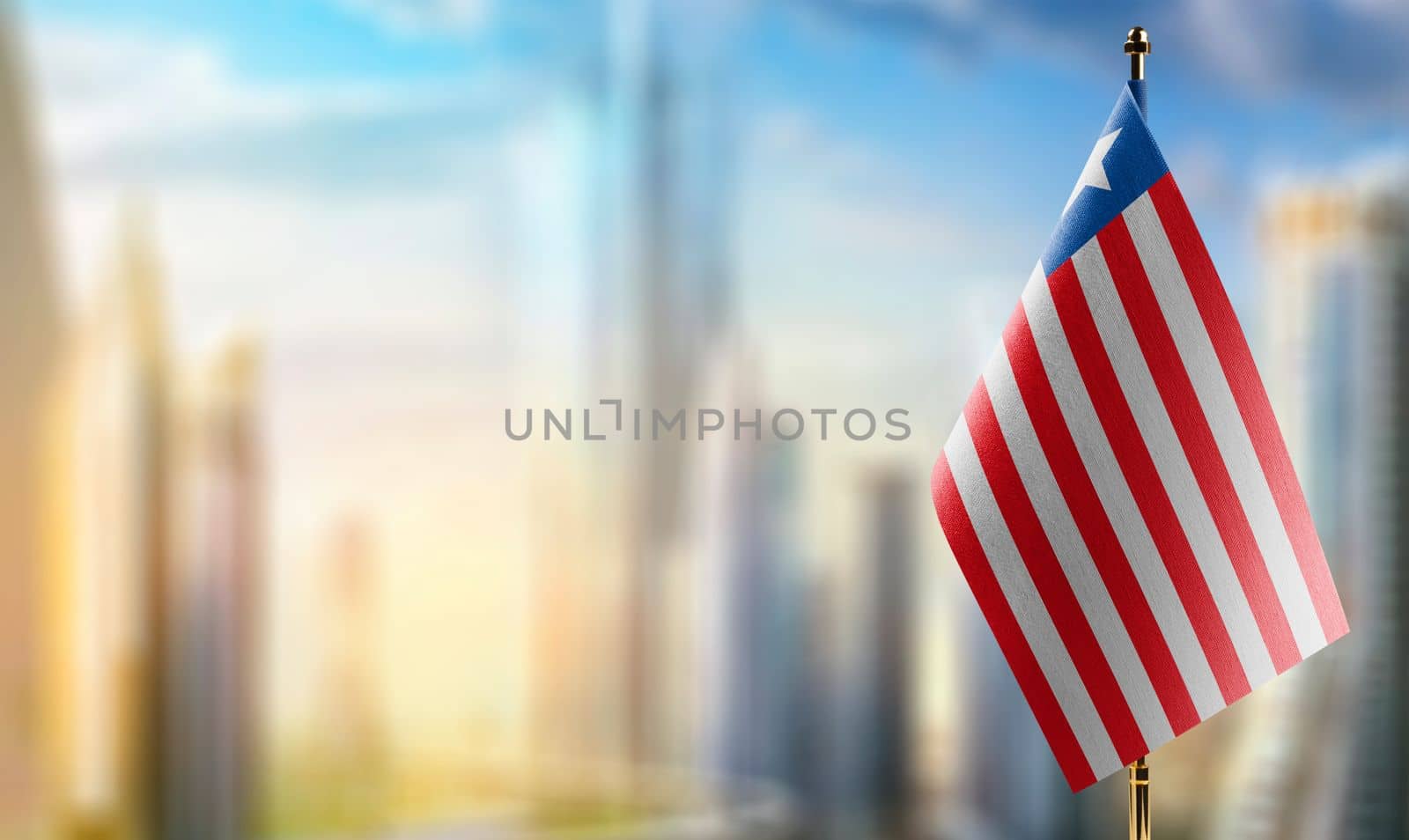 Small flags of the Liberia on an abstract blurry background by butenkow