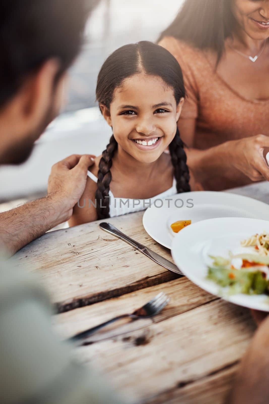 This is our favorite time to bond. a happy young family enjoying a meal together outdoors