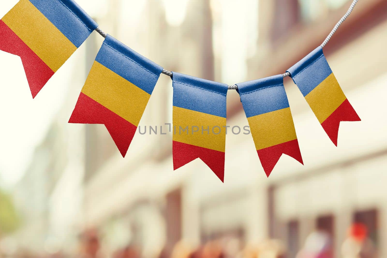 A garland of Chad national flags on an abstract blurred background.