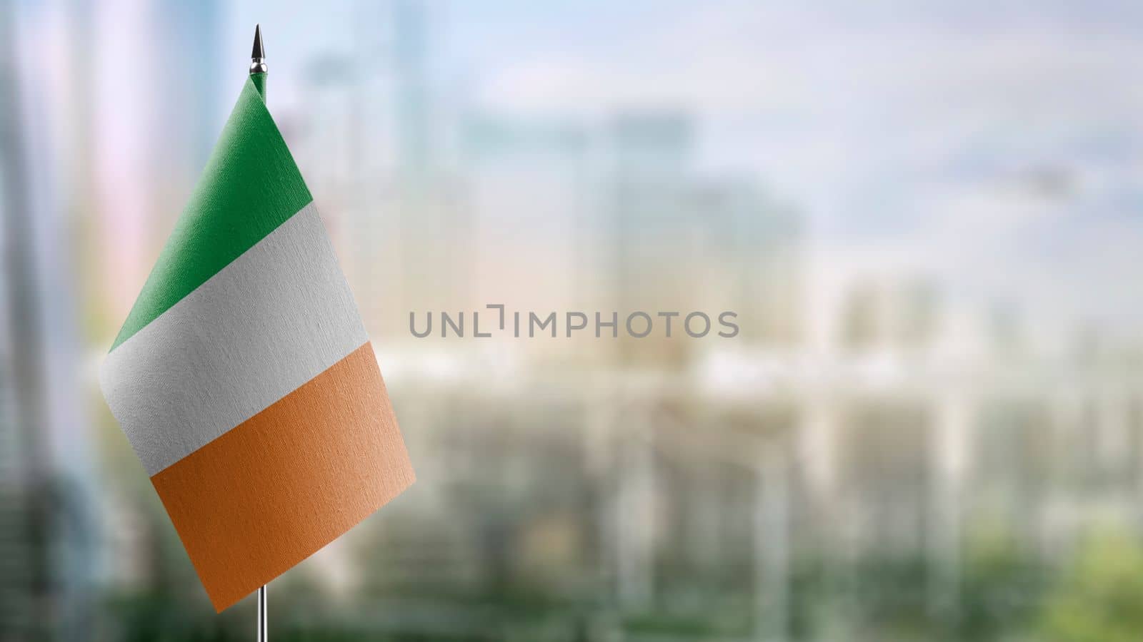 Small flags of the Ireland on an abstract blurry background.