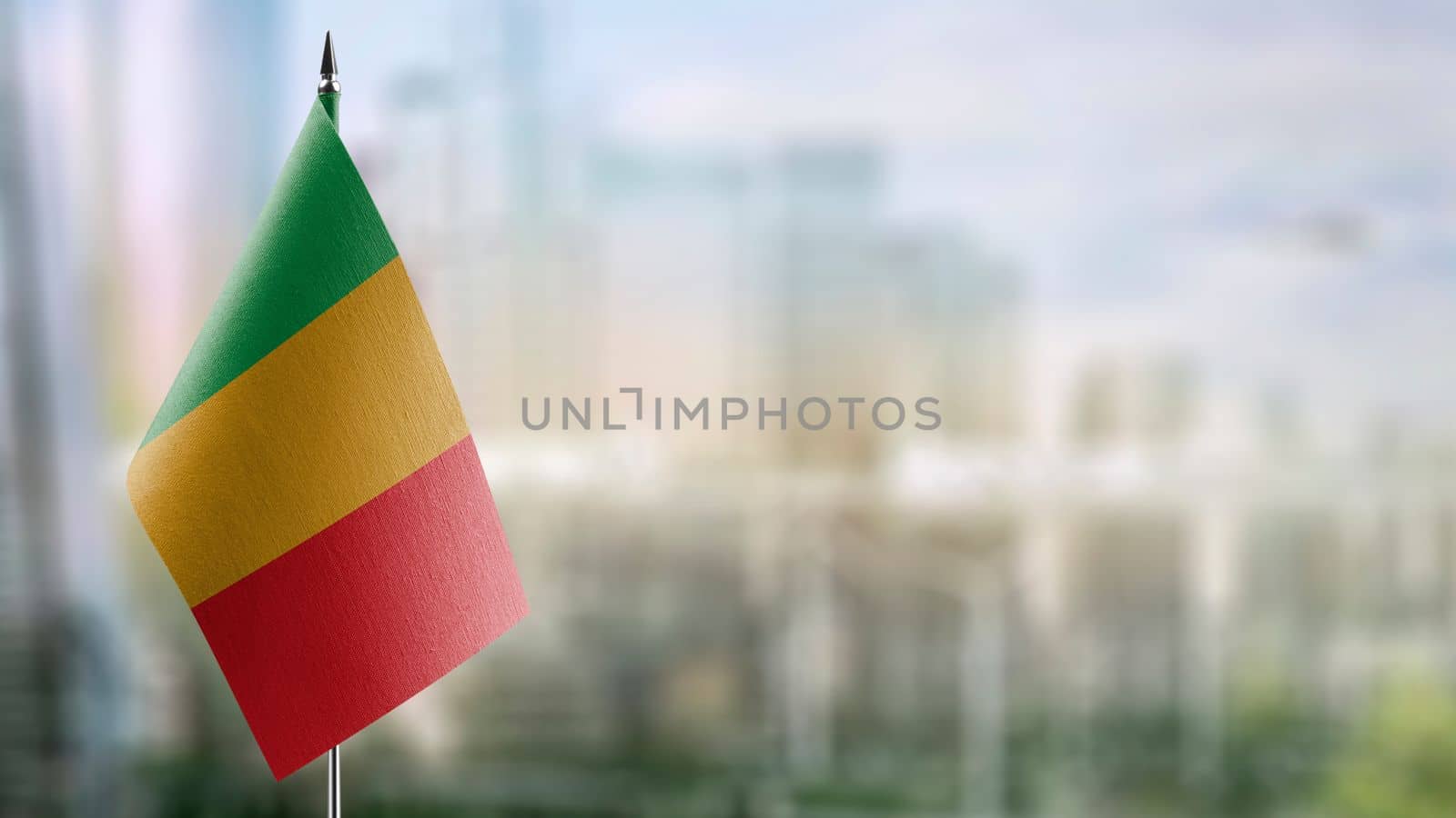 Small flags of the Mali on an abstract blurry background by butenkow