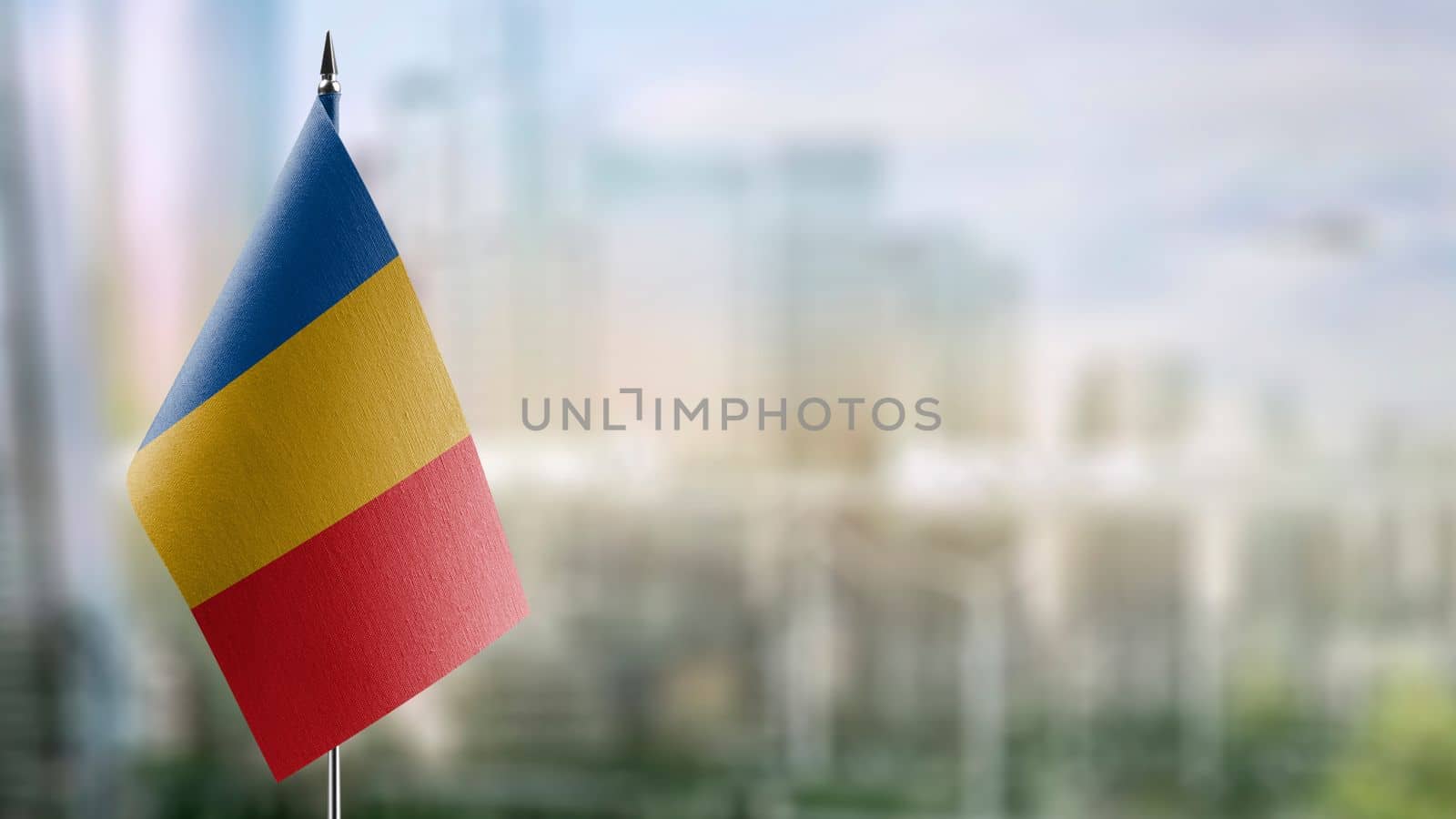 Small flags of the Chad on an abstract blurry background by butenkow