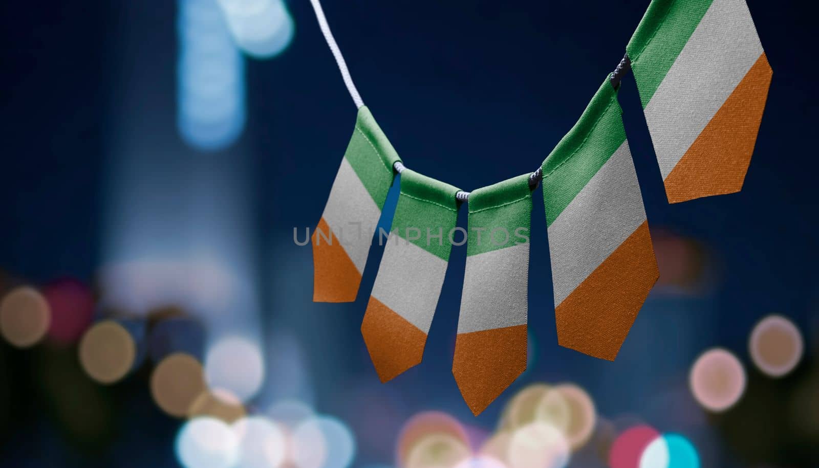 A garland of Ireland national flags on an abstract blurred background.