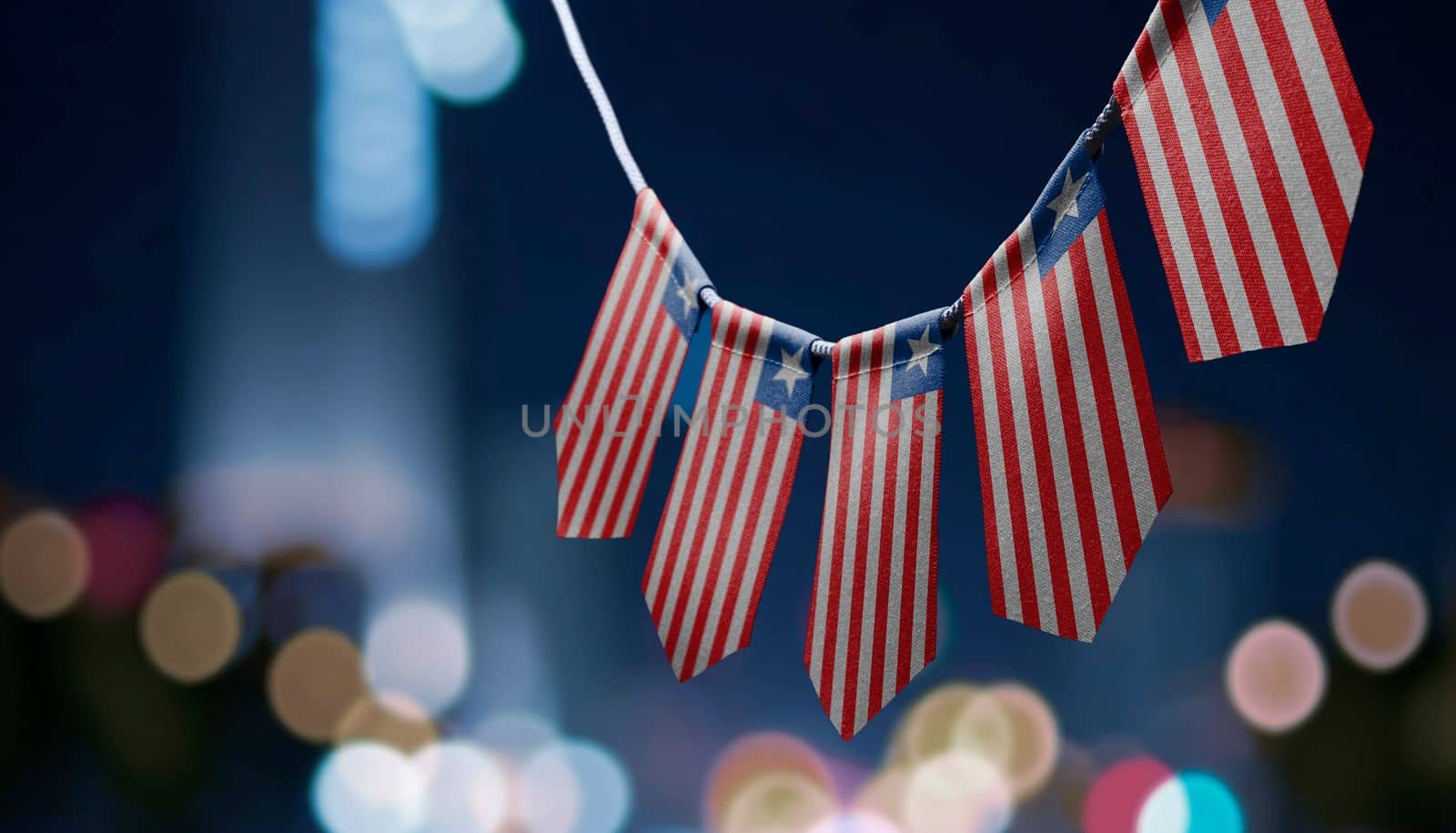 A garland of Liberia national flags on an abstract blurred background.