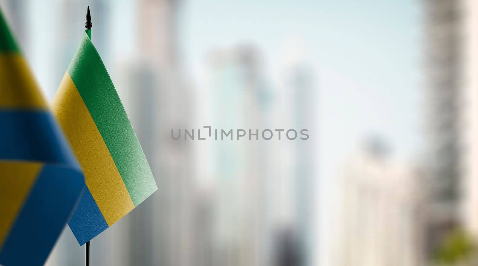 Small flags of the Gabon on an abstract blurry background.