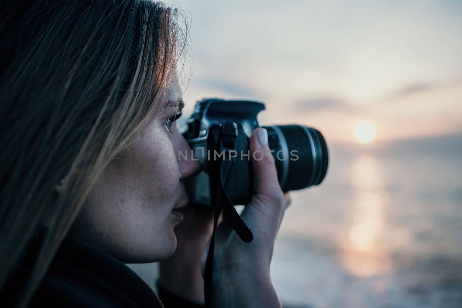 Woman travel sea. Happy tourist taking picture outdoors for memories. Woman traveler looks at the edge of the cliff on the sea bay of mountains, sharing travel adventure journey.