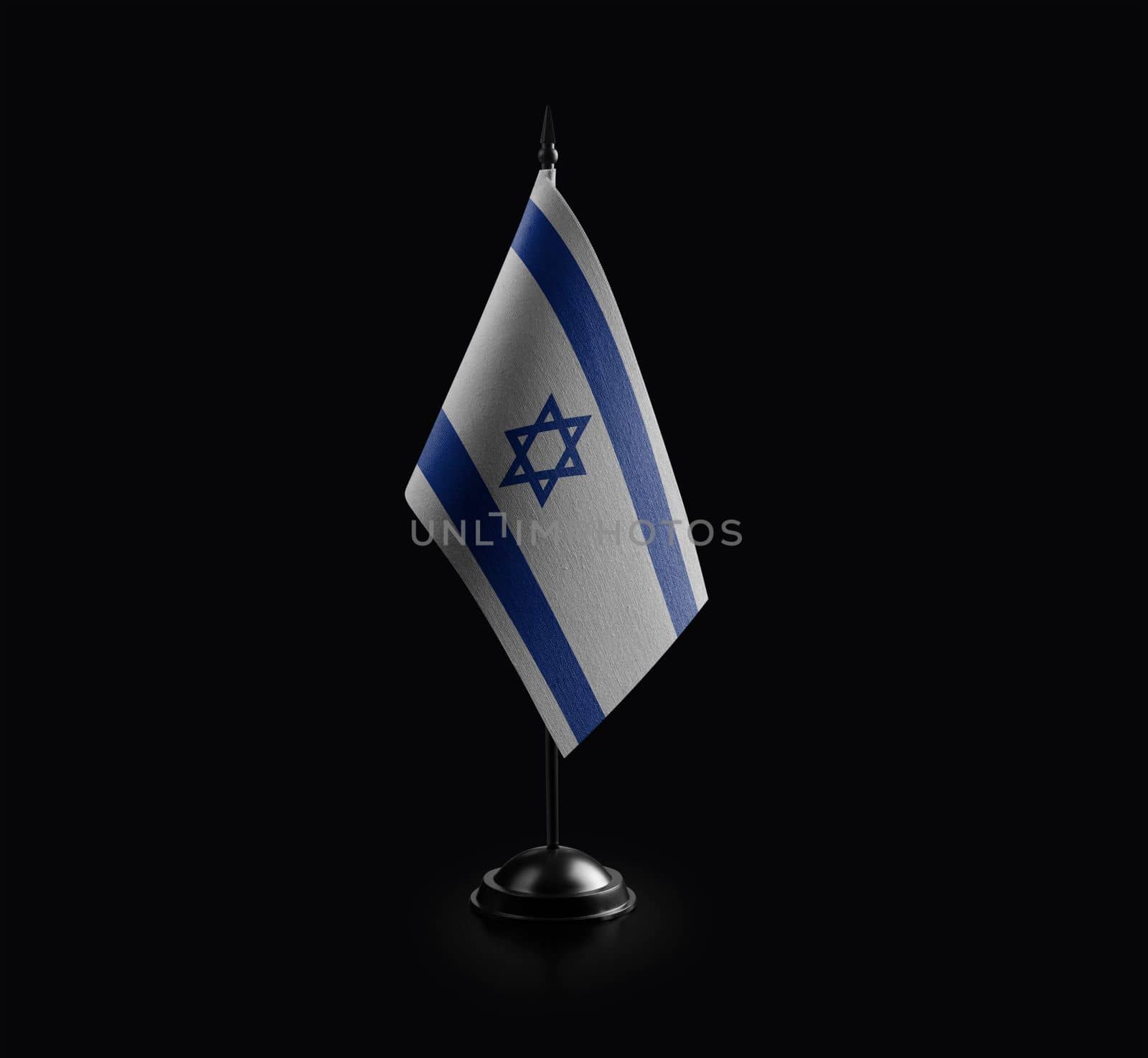 Small national flag of the Israel on a black background.