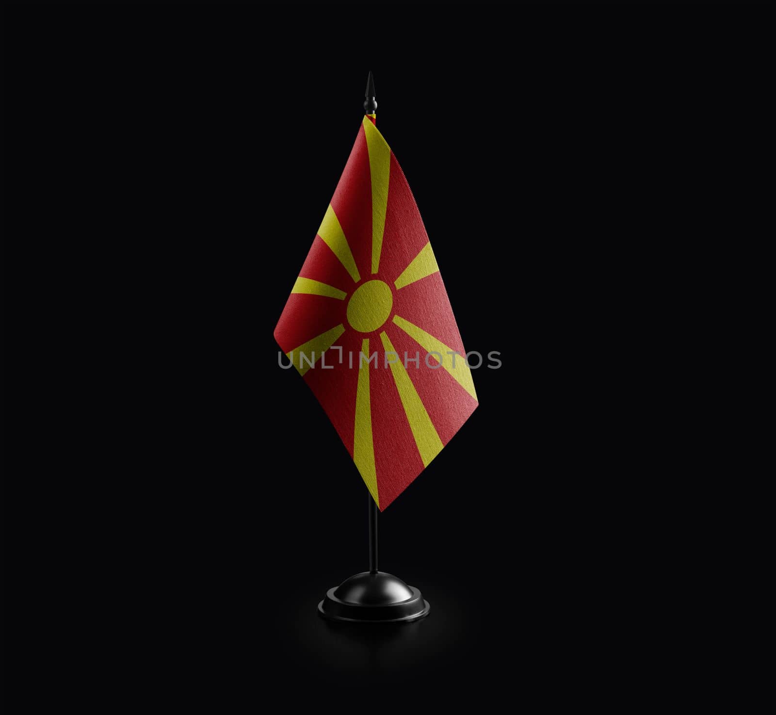 Small national flag of the Macedonia on a black background by butenkow
