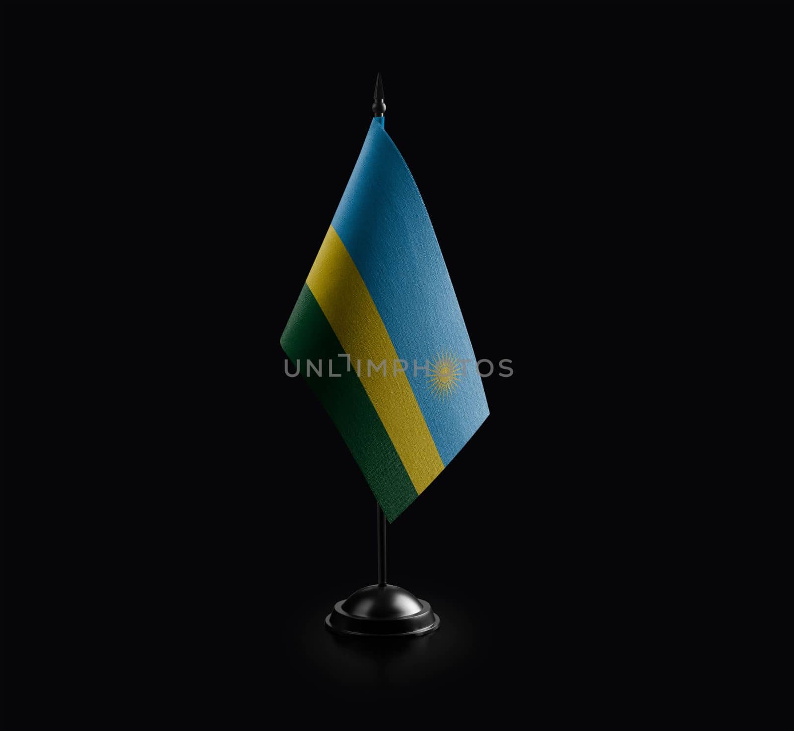 Small national flag of the Rwanda on a black background by butenkow