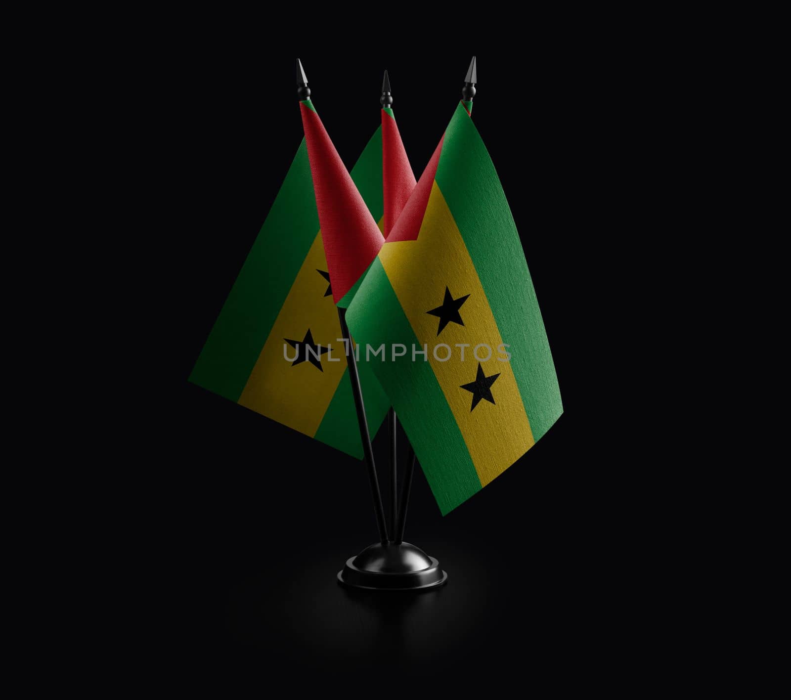 Small national flags of the Sao Tome and Principe on a black background by butenkow
