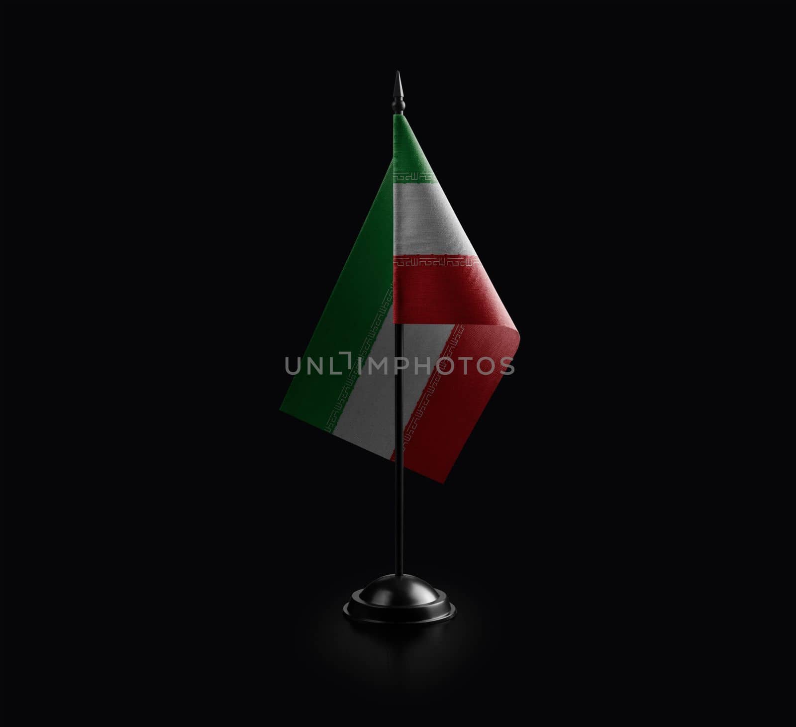 Small national flag of the Iran on a black background.