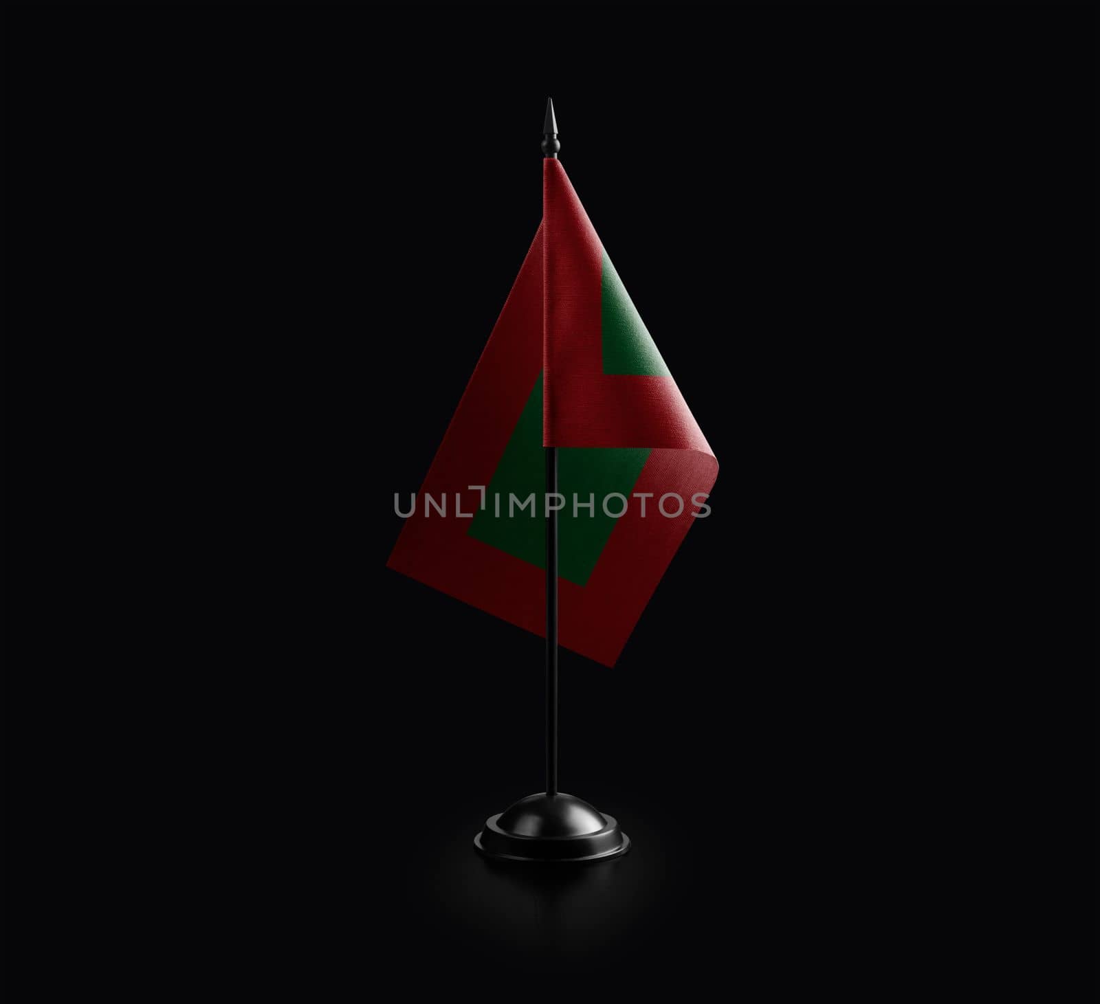 Small national flag of the Maldives on a black background by butenkow