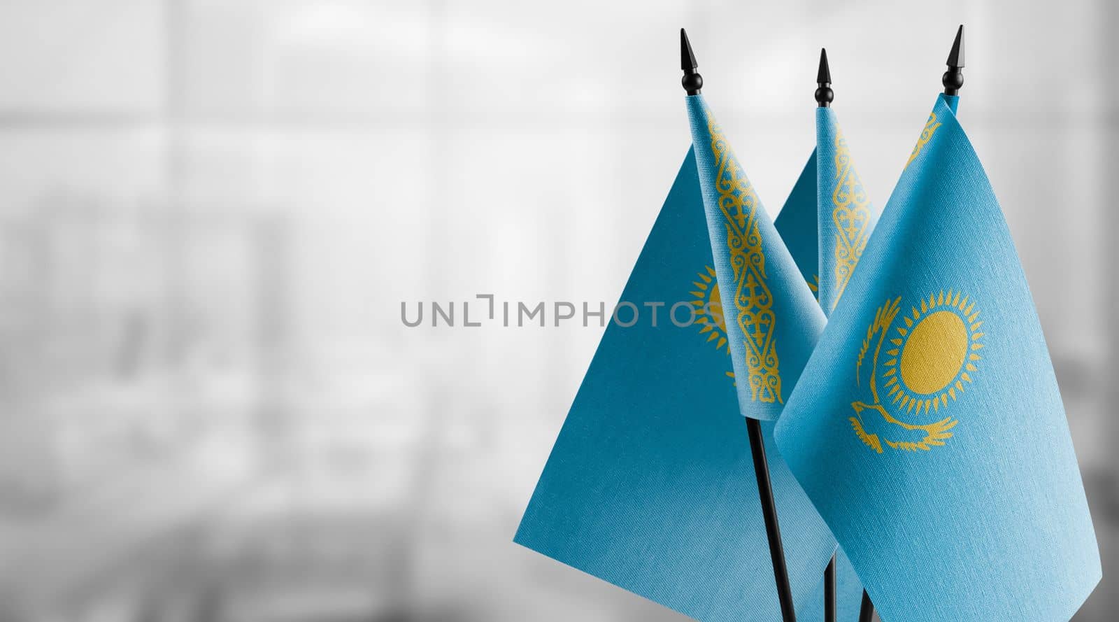 A small Kazakhstan flag on an abstract blurry background by butenkow