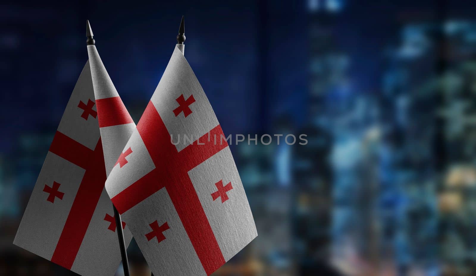 A small Georgia flag on an abstract blurry background.