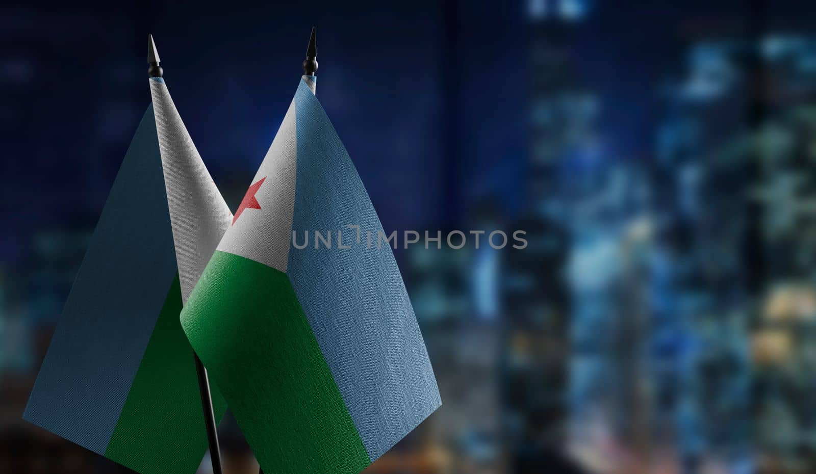 Small flags of the Djibouti on an abstract blurry background by butenkow