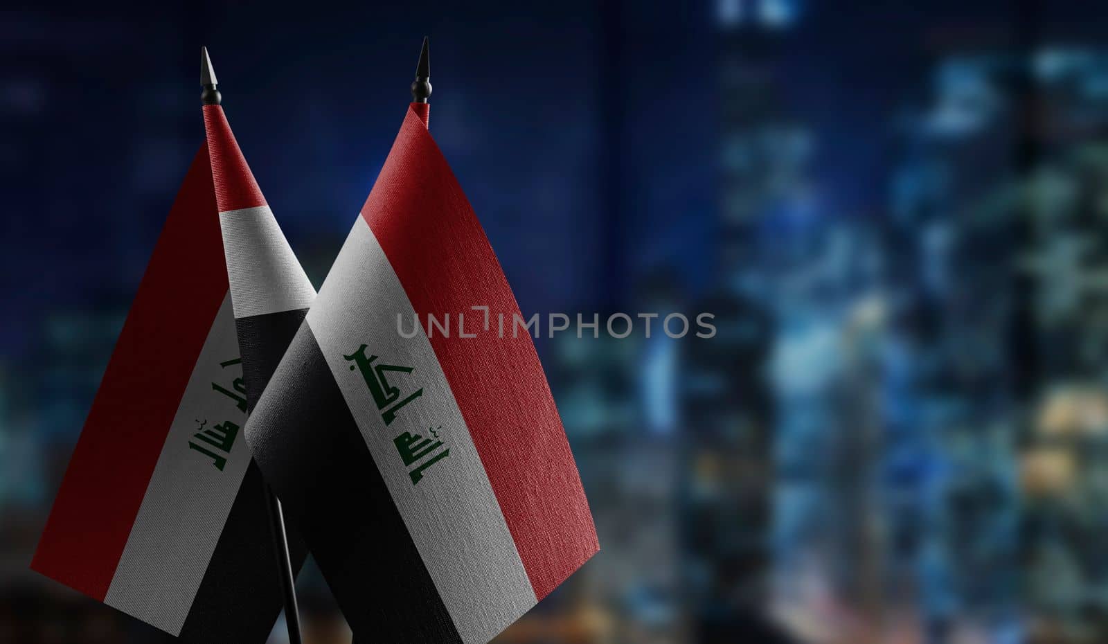 Small flags of the Iraq on an abstract blurry background by butenkow