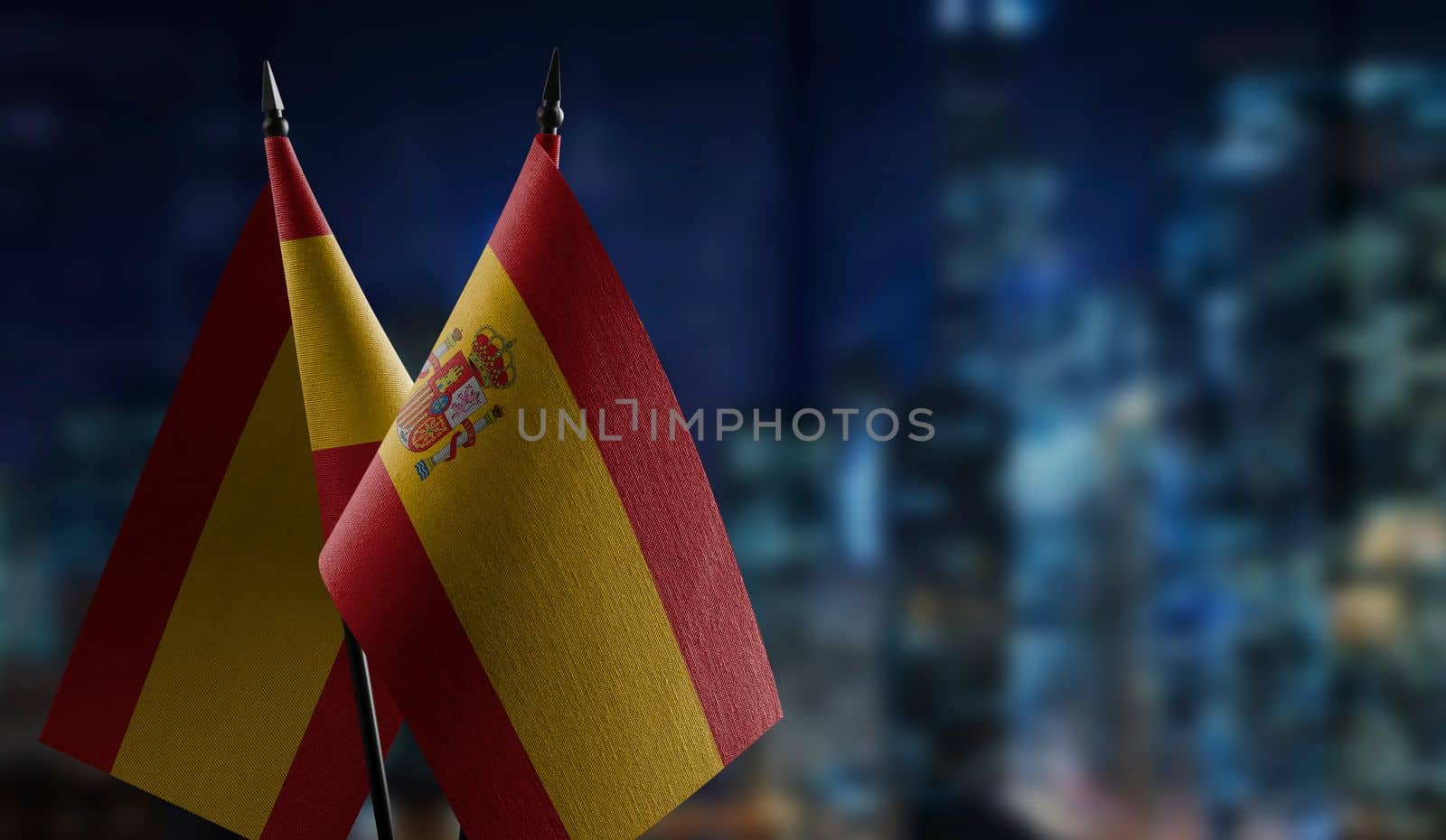 A small Spain flag on an abstract blurry background.
