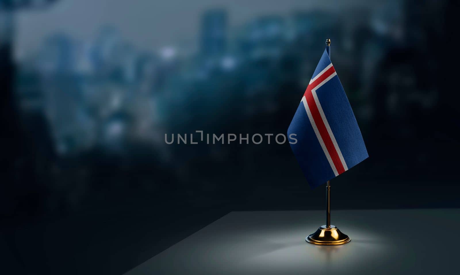 Small flags of the Iceland on an abstract blurry background by butenkow