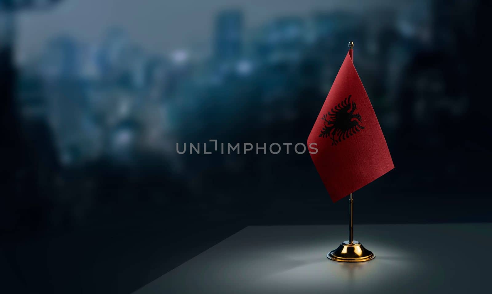 A small Albania flag on an abstract blurry background by butenkow