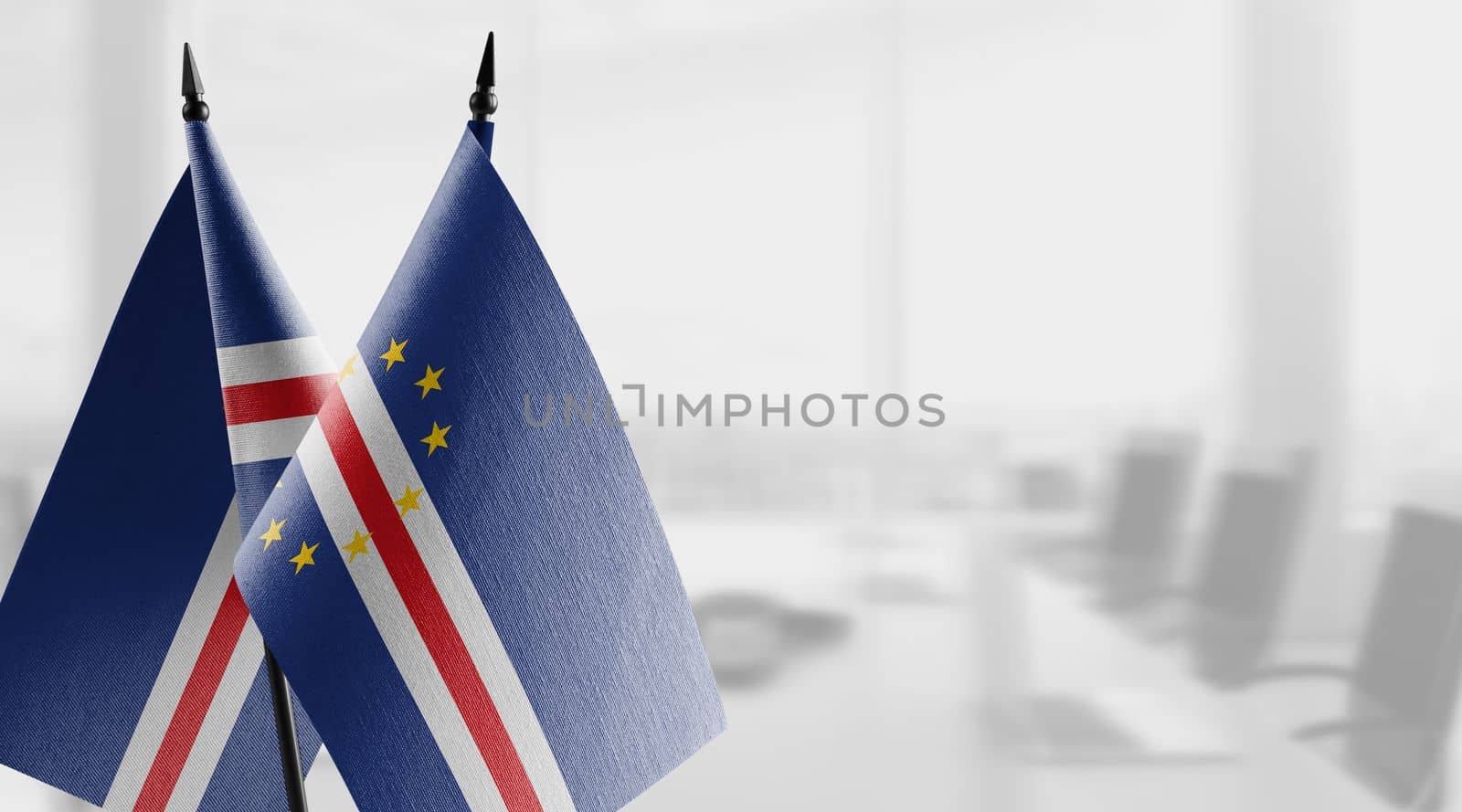 Small flags of the Cape Verde on an abstract blurry background.