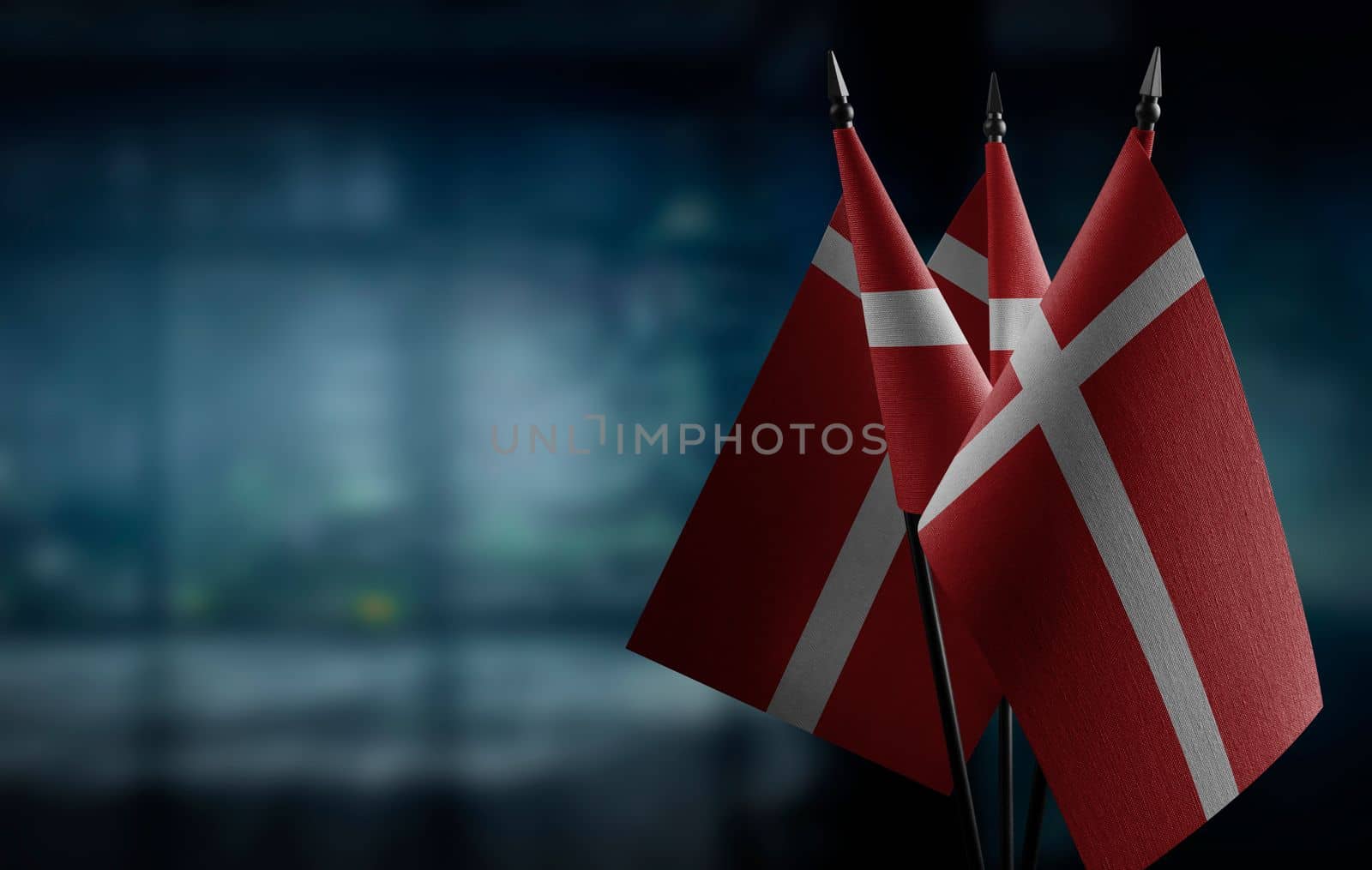 A small Denmark flag on an abstract blurry background.