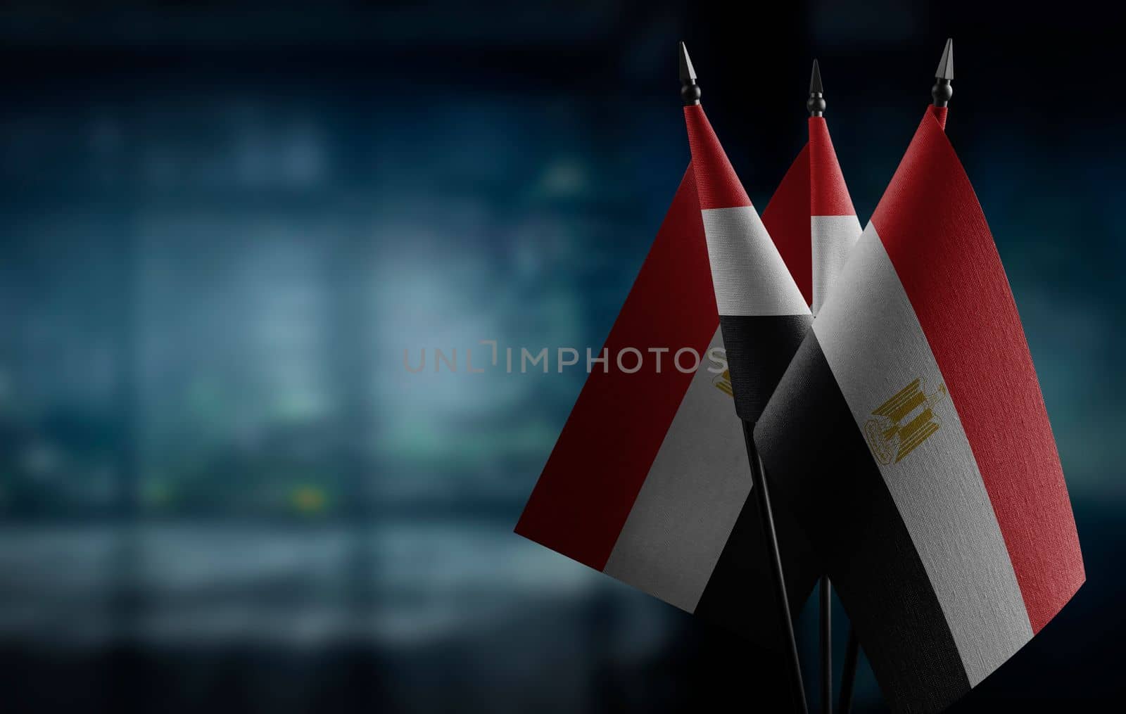 A small Egypt flag on an abstract blurry background by butenkow