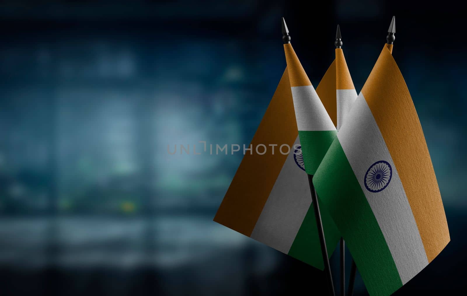 A small India flag on an abstract blurry background.