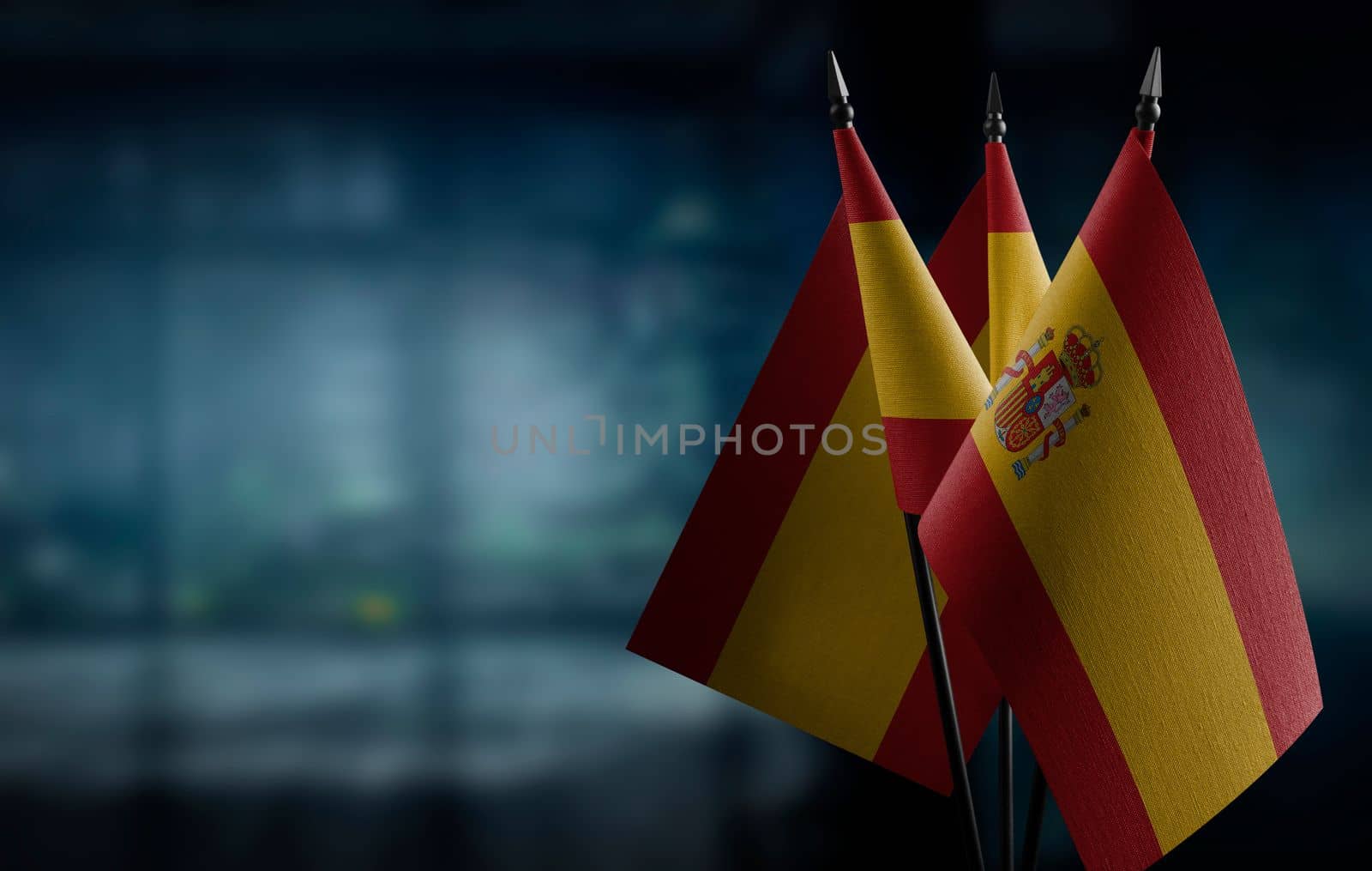 A small Spain flag on an abstract blurry background by butenkow