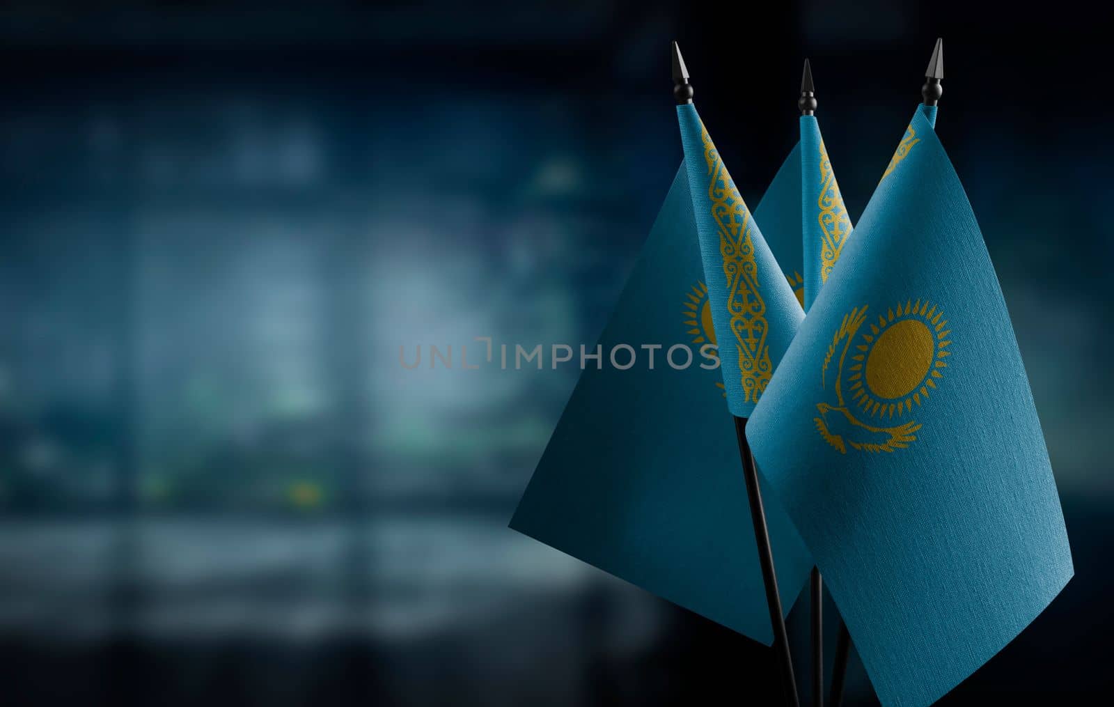 A small Kazakhstan flag on an abstract blurry background by butenkow