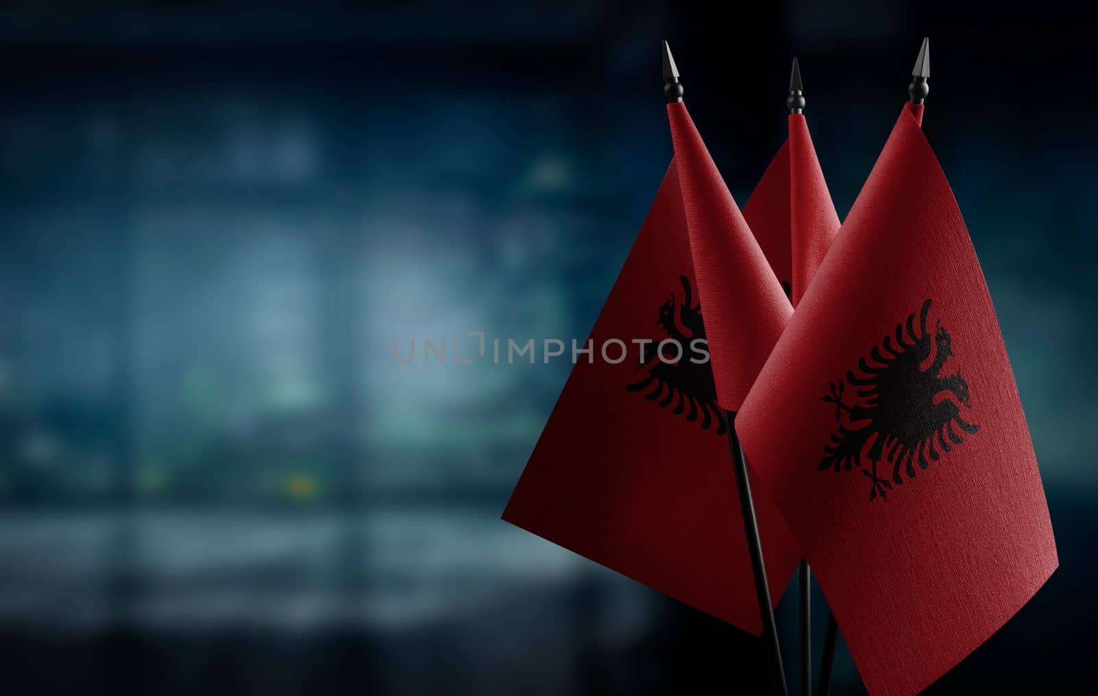 A small Albania flag on an abstract blurry background by butenkow