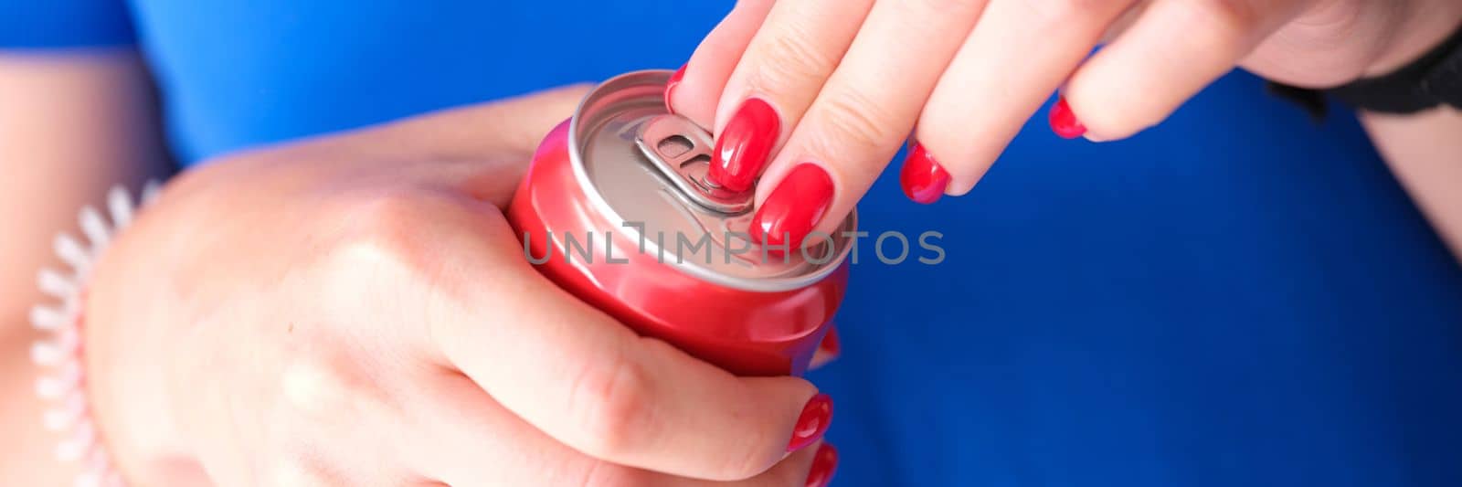 Closeup of female hands opening can of drink. Drink in aluminum cans concept